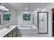 Bright bathroom with a walk-in shower, soaking tub, double sink vanity, and large window at 6520 Fairfield Trce, Suwanee, GA 30024