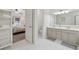 Spacious open bathroom leads into the bedroom, featuring double sinks and tile flooring at 6520 Fairfield Trce, Suwanee, GA 30024