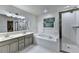 Primary bathroom with double sinks, a soaking tub and a glass enclosed shower at 6520 Fairfield Trce, Suwanee, GA 30024