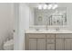 Double vanity, white countertops, in a bright bathroom with glass shower and toilet area at 6520 Fairfield Trce, Suwanee, GA 30024