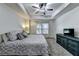 Spacious bedroom with neutral paint, a ceiling fan, a tray ceiling and carpet flooring at 6520 Fairfield Trce, Suwanee, GA 30024