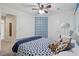 A cozy, carpeted bedroom provides a white bed, blue trim, ceiling fan, and closet at 6520 Fairfield Trce, Suwanee, GA 30024