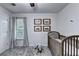 Bright, neutral Bedroom with framed vehicle pictures above the crib and gray rocking horse at 6520 Fairfield Trce, Suwanee, GA 30024
