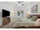 Spacious bedroom with tray ceilings, natural light, and a ceiling fan at 6520 Fairfield Trce, Suwanee, GA 30024