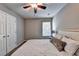 Cozy bedroom featuring neutral walls, a ceiling fan, and soft bedding with a cushioned headboard at 6520 Fairfield Trce, Suwanee, GA 30024