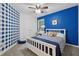A beautifully painted blue accent wall is the highlight of this cozy, carpeted bedroom at 6520 Fairfield Trce, Suwanee, GA 30024
