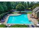 Community pool and tennis court area with pool, hot tub, seating, well-maintained landscaping, and recreational space at 6520 Fairfield Trce, Suwanee, GA 30024