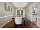 Elegant dining room with hardwood floors, modern chandelier, and views to outdoor greenery at 6520 Fairfield Trce, Suwanee, GA 30024