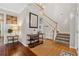 Elegant foyer with hardwood floors, staircase, and a decorative table against a light gray wall at 6520 Fairfield Trce, Suwanee, GA 30024