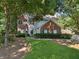 Traditional brick and siding home with a manicured lawn and mature landscaping at 6520 Fairfield Trce, Suwanee, GA 30024