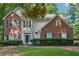 Charming two-story home featuring brick accents, classic shutters, and a well-manicured lawn at 6520 Fairfield Trce, Suwanee, GA 30024