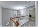 Second floor hallway features carpeting, natural light, and neutral paint at 6520 Fairfield Trce, Suwanee, GA 30024