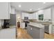 Modern kitchen features granite countertops, stainless steel appliances, and white cabinets at 6520 Fairfield Trce, Suwanee, GA 30024