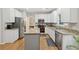 Bright kitchen features granite countertops, stainless steel appliances, and a center island at 6520 Fairfield Trce, Suwanee, GA 30024