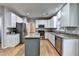 Bright kitchen with stainless steel appliances, granite countertops, and white cabinetry at 6520 Fairfield Trce, Suwanee, GA 30024