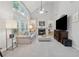 Bright living room with tall windows, a fireplace, built-in bookshelves, and plush carpet at 6520 Fairfield Trce, Suwanee, GA 30024