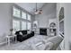 Bright living room with vaulted ceilings, large windows, a cozy fireplace, and custom built-in shelving at 6520 Fairfield Trce, Suwanee, GA 30024