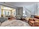 Bright living room featuring hardwood floors, staircase, and an open layout leading to the dining area at 6520 Fairfield Trce, Suwanee, GA 30024