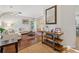 Bright living room with hardwood floors, stylish furniture, and a view into the adjacent dining area at 6520 Fairfield Trce, Suwanee, GA 30024