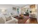 Comfortable living area with hardwood floors, stylish decor, and an open view to the dining room at 6520 Fairfield Trce, Suwanee, GA 30024
