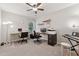 A bright office provides two work areas, black office furniture, and overhead fan at 6520 Fairfield Trce, Suwanee, GA 30024