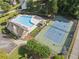 A beautiful aerial view displays a community pool and tennis court on a bright, sunny day at 6520 Fairfield Trce, Suwanee, GA 30024