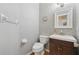 Charming powder room with wood floors, wallpaper and a modern sink with vanity at 6520 Fairfield Trce, Suwanee, GA 30024