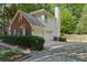 Rear view of home showing garage, siding, and a manicured yard at 6520 Fairfield Trce, Suwanee, GA 30024