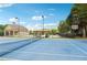 Community tennis court and pool with a gazebo and nearby pool house at 6520 Fairfield Trce, Suwanee, GA 30024