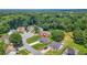 Aerial shot showing a home in a residential area surrounded by mature trees and well-kept lawns at 1890 Owens Trl, Rex, GA 30273