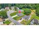 Aerial view of a home with a long driveway and manicured lawn in a tree-lined suburban neighborhood at 1890 Owens Trl, Rex, GA 30273