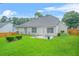 A well-manicured backyard featuring a patio and lush green grass at 1890 Owens Trl, Rex, GA 30273