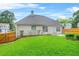 Grassy backyard features a seating area and wood fence providing ample privacy at 1890 Owens Trl, Rex, GA 30273