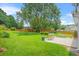 Spacious backyard with green grass, patio, landscaping and wooden fence at 1890 Owens Trl, Rex, GA 30273