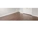 Bedroom featuring wood-look floors, neutral gray walls, white trim, and a closet at 1890 Owens Trl, Rex, GA 30273