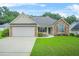 Charming single-story home featuring a well-manicured lawn and attached two-car garage at 1890 Owens Trl, Rex, GA 30273
