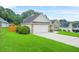Exterior view of a single-story home with attached garage and verdant lawn at 1890 Owens Trl, Rex, GA 30273
