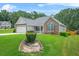 Exterior of a single-story home with two-car garage, attractive stone accents, and a lovely front yard at 1890 Owens Trl, Rex, GA 30273