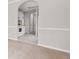 This well-lit hallway offers a view into the eat-in kitchen with white appliances and cabinets at 1890 Owens Trl, Rex, GA 30273