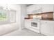 Well-designed kitchen with white cabinets, granite countertops, and modern appliances at 1890 Owens Trl, Rex, GA 30273