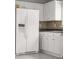 Kitchen features include a side by side refrigerator and a tile backsplash at 1890 Owens Trl, Rex, GA 30273