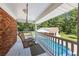 Charming outdoor porch featuring a swing and view of the backyard pool at 1961 Luke Edwards Rd, Dacula, GA 30019