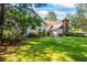 The backyard features a well-maintained lawn, mature trees, and partial views of the home, creates an outdoor oasis at 1961 Luke Edwards Rd, Dacula, GA 30019