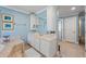 Luxurious bathroom with marble tile, a soaking tub, and dual sink vanity at 1961 Luke Edwards Rd, Dacula, GA 30019