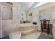 Luxurious bathroom featuring a soaking tub, walk-in shower, and bright window at 1961 Luke Edwards Rd, Dacula, GA 30019