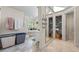 Bright bathroom featuring a soaking tub, walk-in closet, and tile floors at 1961 Luke Edwards Rd, Dacula, GA 30019