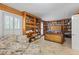 Cozy bedroom with built-in wooden bookshelves and natural light from window with white shutters at 1961 Luke Edwards Rd, Dacula, GA 30019