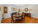 Charming dining room with fireplace, hardwood floors, classic decor and an oval table at 1961 Luke Edwards Rd, Dacula, GA 30019