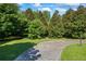 Circular driveway bordered by lush greenery, enhancing the property's curb appeal and providing ample parking at 1961 Luke Edwards Rd, Dacula, GA 30019