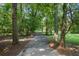 Long, private driveway flanked by mature trees, leading to a secluded and tranquil property at 1961 Luke Edwards Rd, Dacula, GA 30019
